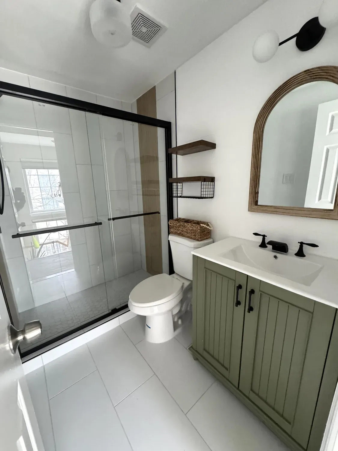 Bathroom remodel with custom vanity and walk-in shower by Building America Construction